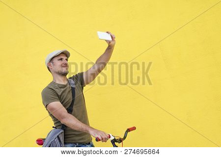 Hipster Man Taking A Selfie . He Is Commuting, He Has A Fixed Gear Bike. Lifestyle, Travel And Susta