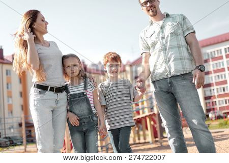 happy family standing in the courtyard of an apartment building