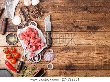 Raw Lean Diced Casserole Beef Pork Steak With Vintage Meat Hatchet And Knife On Wooden Background. S