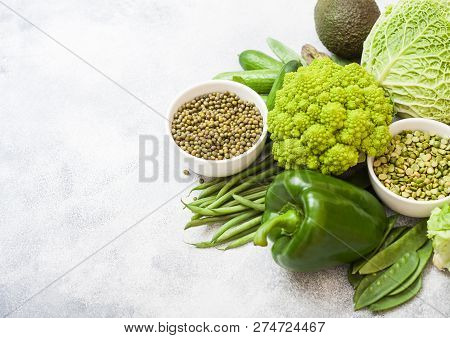 Assorted Green Toned Raw Organic Vegetables On White Background. Avocado, Cabbage, Broccoli, Caulifl