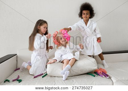 Little Girls Play With Hair Curlers And Hairpins.
