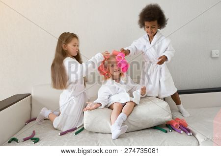 Little Girls Play With Hair Curlers And Hairpins.