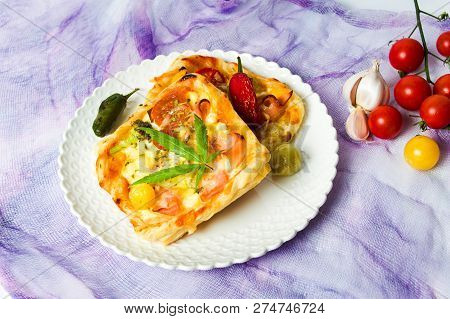 Pizza Pastry Slices With Marijuana On A Plate Top View