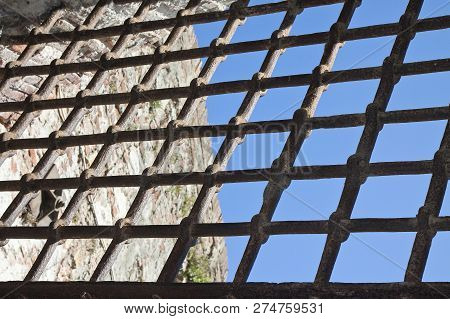 Metal Grate Against A Blue Sky - Freedom Concept