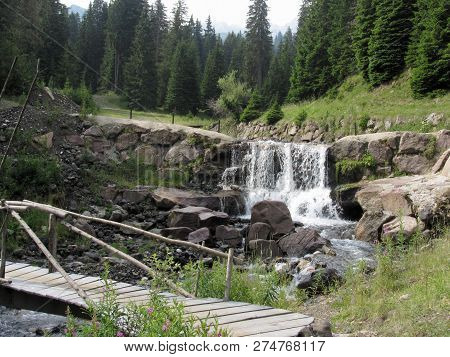 Water Flowing And Splashing Over Rocks In A Mountain River Stream . Siusi Allo Sciliar, South Tyrol,