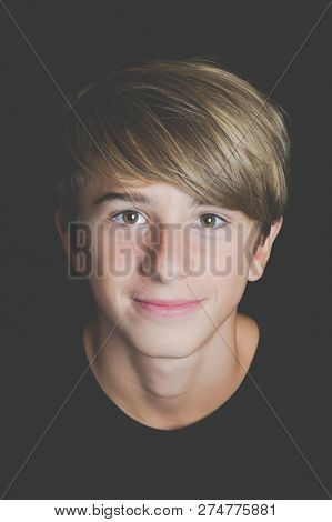 Young Smiling Boy Portrait On Black Background - Concept Of Adolescence Whithout Problems