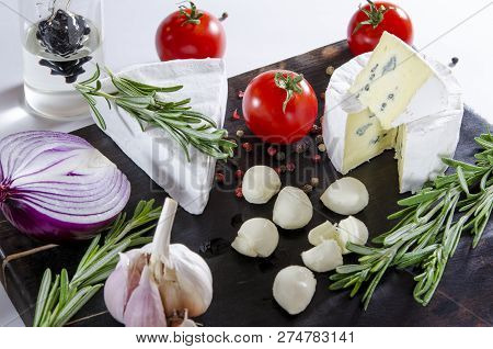 Tasting Cheese Dish With Tomatos On Old Black Dask. Food For Wine And Romantic, Cheese Delicatessen.