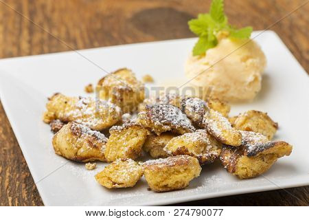 Austrian Kaiserschmarrn With Ice Cream On Dark Wood