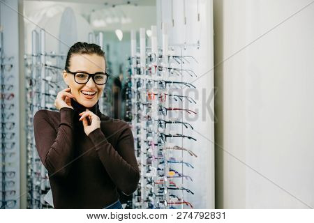 Young Girl Buys Glasses. Optics. Emotions. Ptical Store