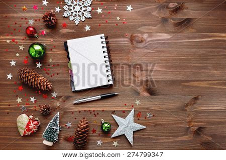 Christmas And New Year Background With Notepad, Pen And Decorati