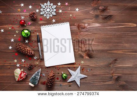 Christmas And New Year Background With Notepad, Pen And Decorati
