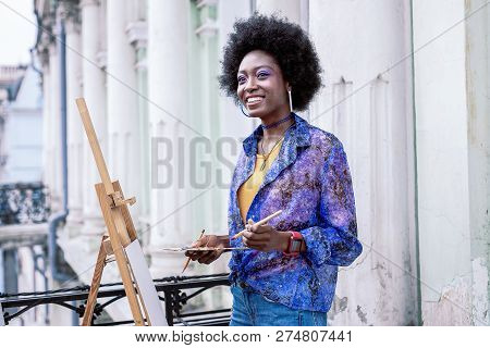 Stylish Artist Feeling Happy While Painting Landscape Outside