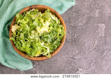 Fresh Frisee Salad In Wooden Bowl. Healthy Food