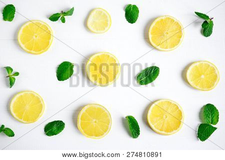 Fresh Lemon Slices On A White Background. Background With Lemon And Mint. Beautiful Photo With Citru