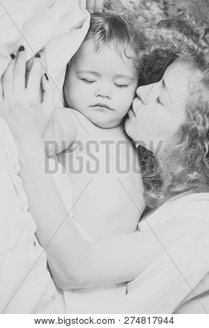 Closeup Of Young Beautiful Loving Mother With Light Blonde Curly Hair Kissing Small Tiny Cute Male L