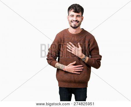 Young handsome man wearing winter sweater over isolated background Smiling and laughing hard out loud because funny crazy joke. Happy expression.