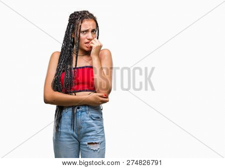 Young braided hair african american with pigmentation blemish birth mark over isolated background looking stressed and nervous with hands on mouth biting nails. Anxiety problem.