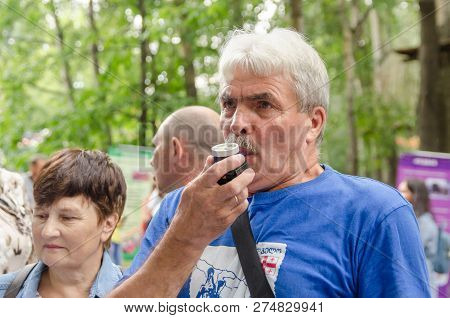 Komsomolsk-on-amur, Russia - August 19, 2018. Elderly Man Blows Into Device To Measure Lung Volume