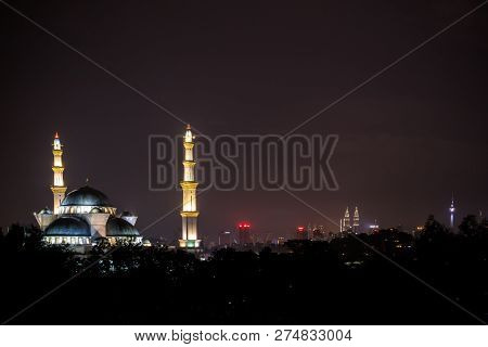 View Of Federal Mosque Of Kuala Lumpur And The City Skyline At Night.
