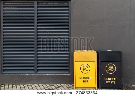 Modern Garbage Can Against The Grey Wall.