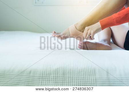Woman Putting Support Silicone For Treatment Plantar Fasciitis On Her Foot