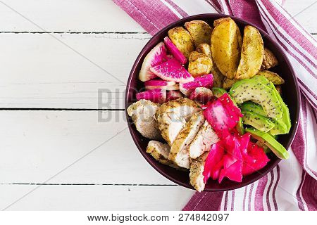 Buddha Bowl Dish With Chicken Fillet, Beked Potato, Avocado, Cabbage, Watermelon Radish And Chia See