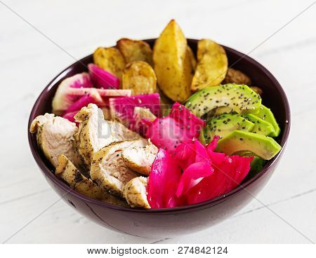Buddha Bowl Dish With Chicken Fillet, Beked Potato, Avocado, Cabbage, Watermelon Radish And Chia See