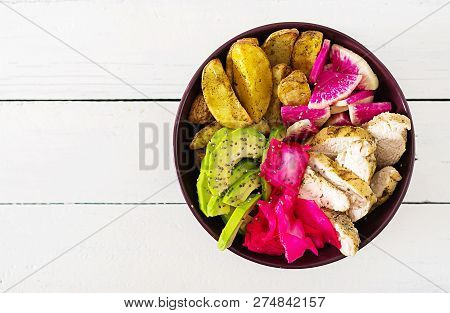 Buddha Bowl Dish With Chicken Fillet, Beked Potato, Avocado, Cabbage, Watermelon Radish And Chia See