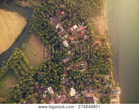 Aerial View Above An Goa Village With Fields And Rivers All Around.