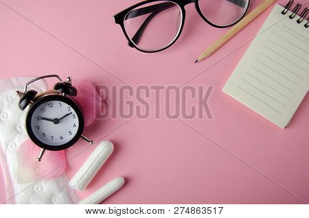 Women's Cycle Hyhienic Pads And Tampons On Pink Background. Copy Space.
