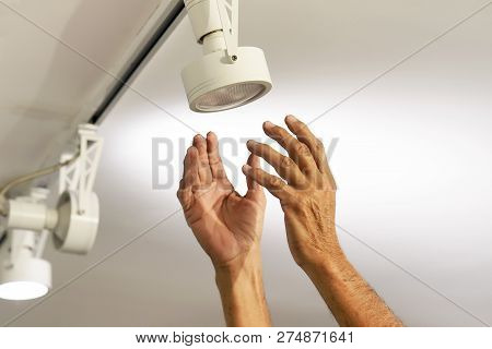 Electric Male Hand Lamps With Ceiling Led Lamp, Spotlight. The Concept Of Repair And Maintenance.
