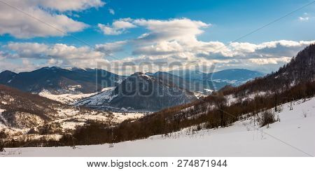 Panorama Of Winter Countryside In Mountains. Wonderful Sunny Day With Gorgeous Cloudscape. Dark Fore