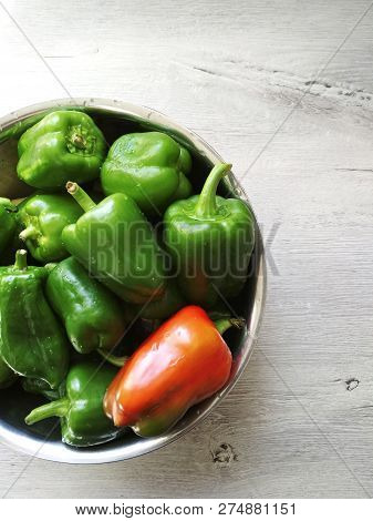 On The Table In A Cup A Lot Of Green Peppers And One Red. Photo For The Menu. Cooking Food. Kitchen 
