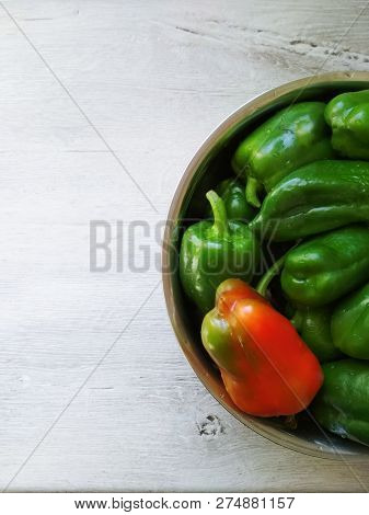 On The Table In A Cup A Lot Of Green Peppers And One Red. Photo For The Menu. Cooking Food. Kitchen 