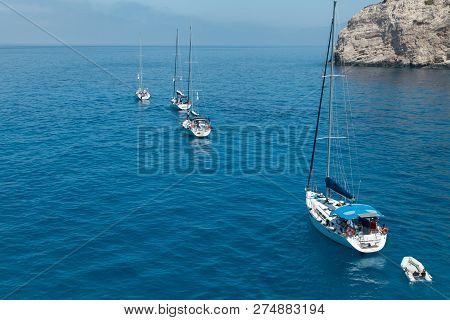 A Flotilla Of Sailing Yachts Out Of The Bay.