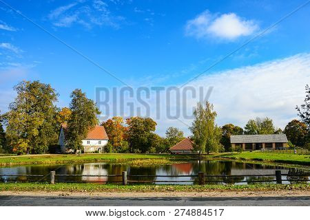 Country Estate Near The Lake And Forest, Sunny Autumn Day.  Leaf Fall Landscape.