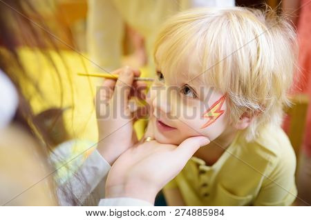 Face Painting For Cute Little Boy During Kids Merriment. Face Paint For 