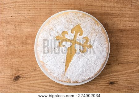 Tarta De Santiago. Traditional Almond Cake From Santiago In Spain On Wooden Table. Top View