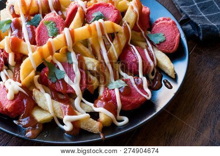 Homemade Peruvian Salchipapa Fries With Sausage Slices, Ketchup And Mayonnaise.