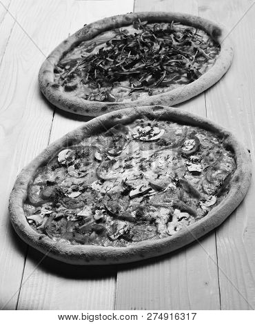 Pizza With Pepperoni, Mushrooms And Egg On Yellow Wooden Background