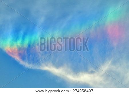 Example Of Wispy Cirrus Cloud Iridescence In A Bright Blue Sky