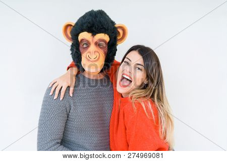 Funny young couple, boyfriend wearing monkey mask, crazy and idiot relationship in love