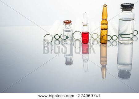 Group Of Vials With Medication On Blue Methacrylate Table. Horizontal Composition.