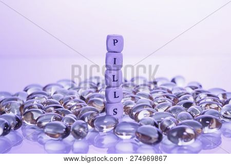 Word Pills From The Letters Of Cubes And Lecithin Gel Pills On Light Background. Soy And Sunflower L