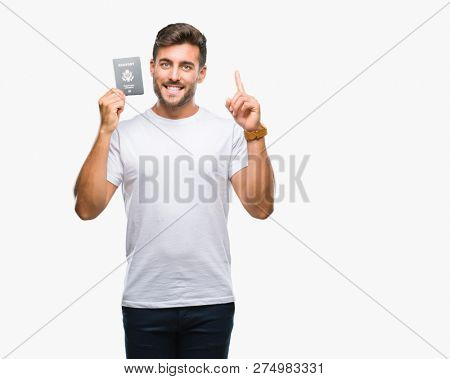 Young handsome man holding passport of united states over isolated background surprised with an idea or question pointing finger with happy face, number one