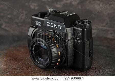 MOSCOW, RUSSIA, DECEMBER 21, 2018. The old Soviet 35 mm SLR camera Zenit 122, released 2001, on gray-brown cement background.