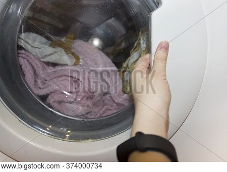 Laundry. Wash Clothes In The Washing Machine.getting Clothes Out Of The Wash