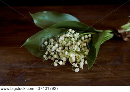 A Bouquet Of Lyses On A Wooden Table. With Copy Space.