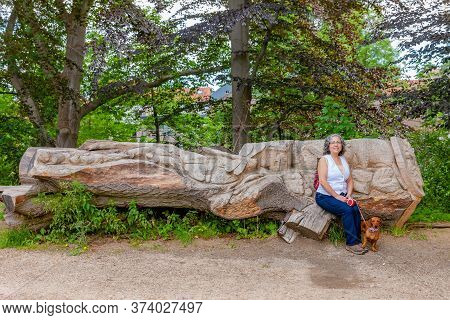 Stein, South Limburg / Netherlands. June 21, 2020. Mature Mexican Woman Sitting On A Carved Log With