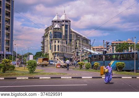 Port Louis Capital, Mauritius, December 2015 - View Of Woman Clad In Sari Crossings The Road In Fron